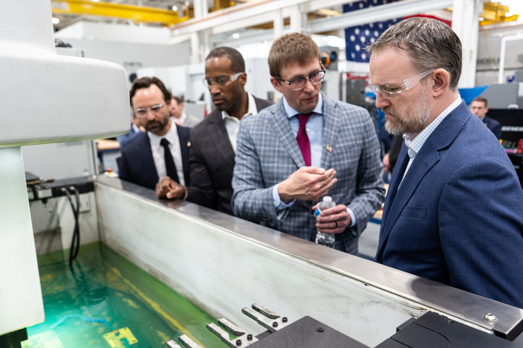 U.S. Trade Representative Jamieson Greer, right, and Rep. John James, R-Mich., second from left, tour the Atomic Industries' manufacturing facility with co-founder and head of manufacturing Lou Young, Jr., second from left, and co-founder and CEO Aaron Slodov, left, Thursday, April 9, 2026, in Warren, Mich. (AP Photo/Julia Demaree Nikhinson)