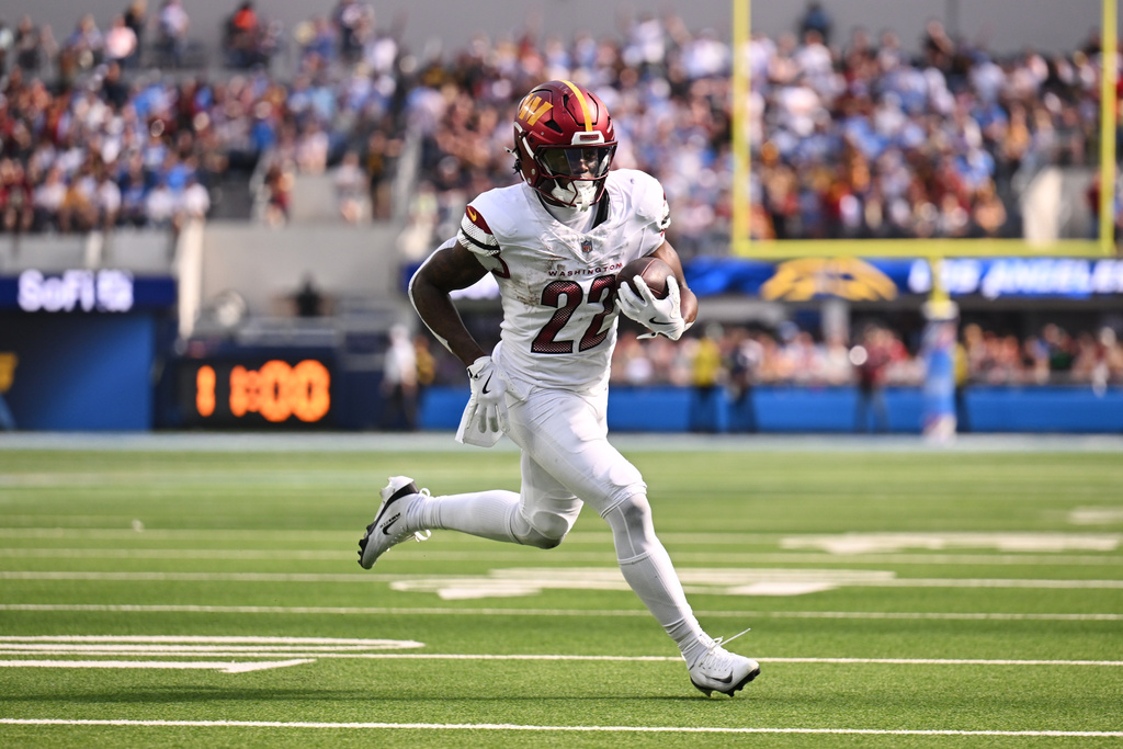 Washington Commanders running back Jacory Croskey-Merritt (22) scores a rushing touchdown during the second half of an NFL football game against the Los Angeles Chargers, Sunday, Oct. 5, 2025, in Inglewood, Calif. (AP Photo/Carrie Giordano )