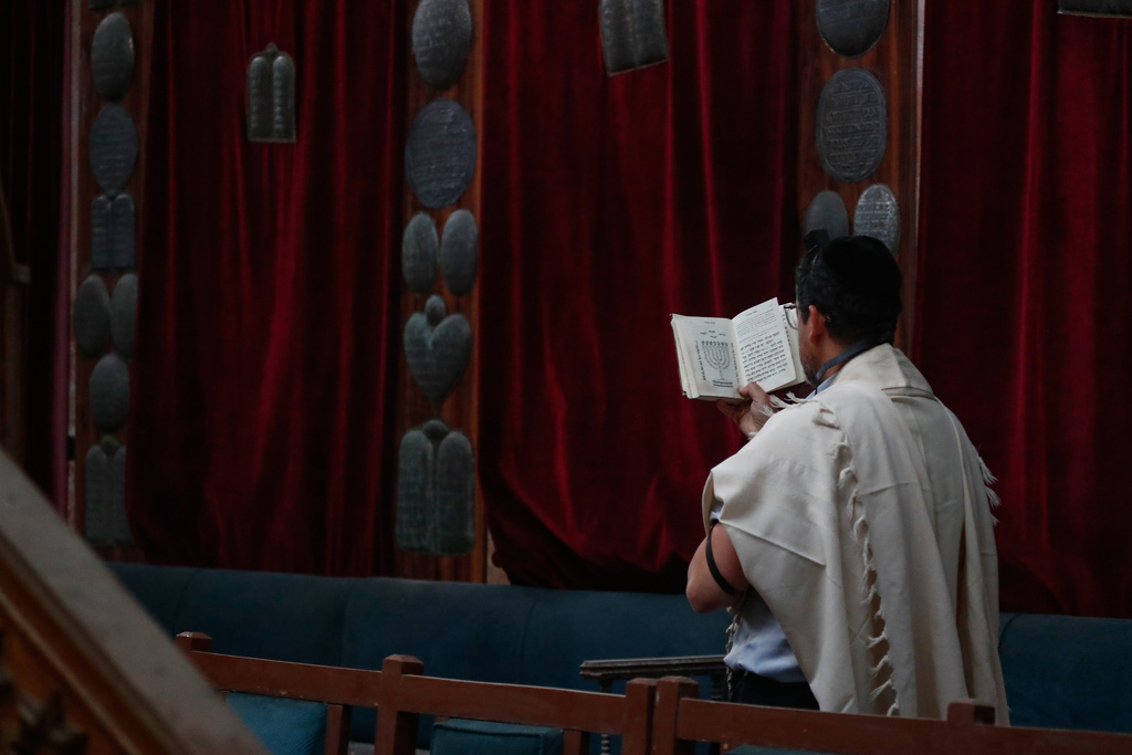 Henry Hamra, a Syrian-American Jew who is one of the founders of a new Jewish heritage initiative, reads the Torah, the Jewish holy book, at al-Firenj Synagogue in the old city of Damascus, Syria, Wednesday, Dec. 10, 2025.(AP Photo/Omar Sanadiki)