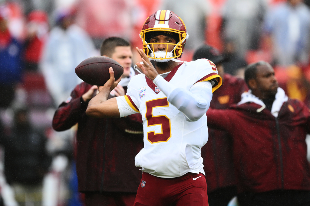 Washington Commanders quarterback Jayden Daniels (5) warms up before an NFL football game against the New York Giants in Landover, Md., Sunday, Oct. 11, 2026. (AP Photo/Nick Wass)