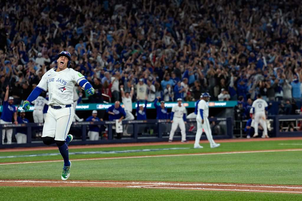 Toronto Blue Jays' George Springer reacts after hitting a three run home run against the Seattle Mariners during the seventh inning in Game 7 of baseball's American League Championship Series, Monday, Oct. 20, 2025, in Toronto. (AP Photo/David J. Phillip)