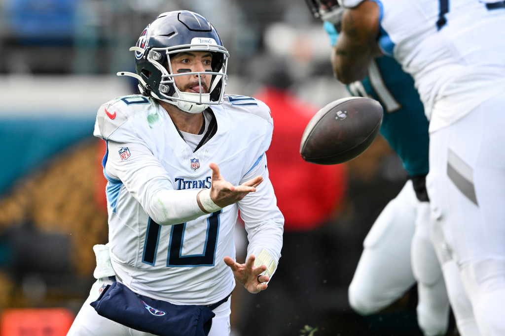 Tennessee Titans quarterback Brandon Allen (10) tosses the ball as he falls to the ground during the second half of an NFL football game, against the Jacksonville Jaguars, Sunday, Jan. 4, 2026, in Jacksonville, Fla. (AP Photo/Phelan M. Ebenhack)