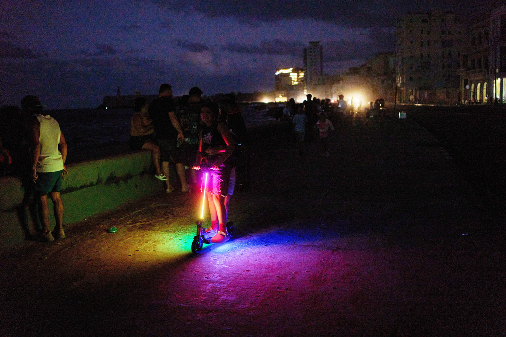 People spend the night on the Malecon during a blackout in Havana, Cuba, Saturday, March 21, 2026. (AP Photo/Ramon Espinosa)