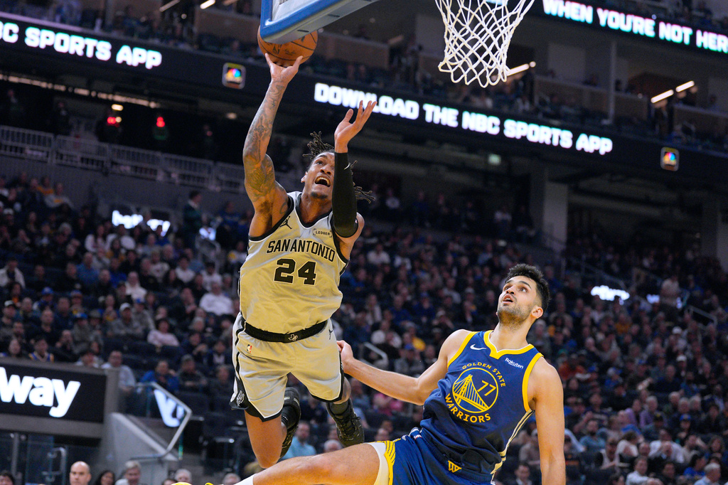 San Antonio Spurs guard Devin Vassell (24) reacts as he is fouled by Golden State Warriors center Omer Yurtseven (77) during the first half of an NBA basketball game in San Francisco, Wednesday, April 1, 2026. (AP Photo/Tony Avelar)