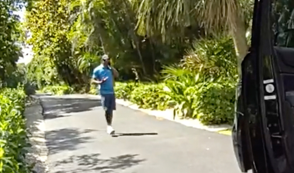 In this image from police body camera video released by the Martin County, Fla., Sheriff's Office, golfer Tiger Woods speaks on his cellphone following a car crash in Jupiter Island, Fla., Friday, March 27, 2026. (Martin County Sheriff's Office via AP)