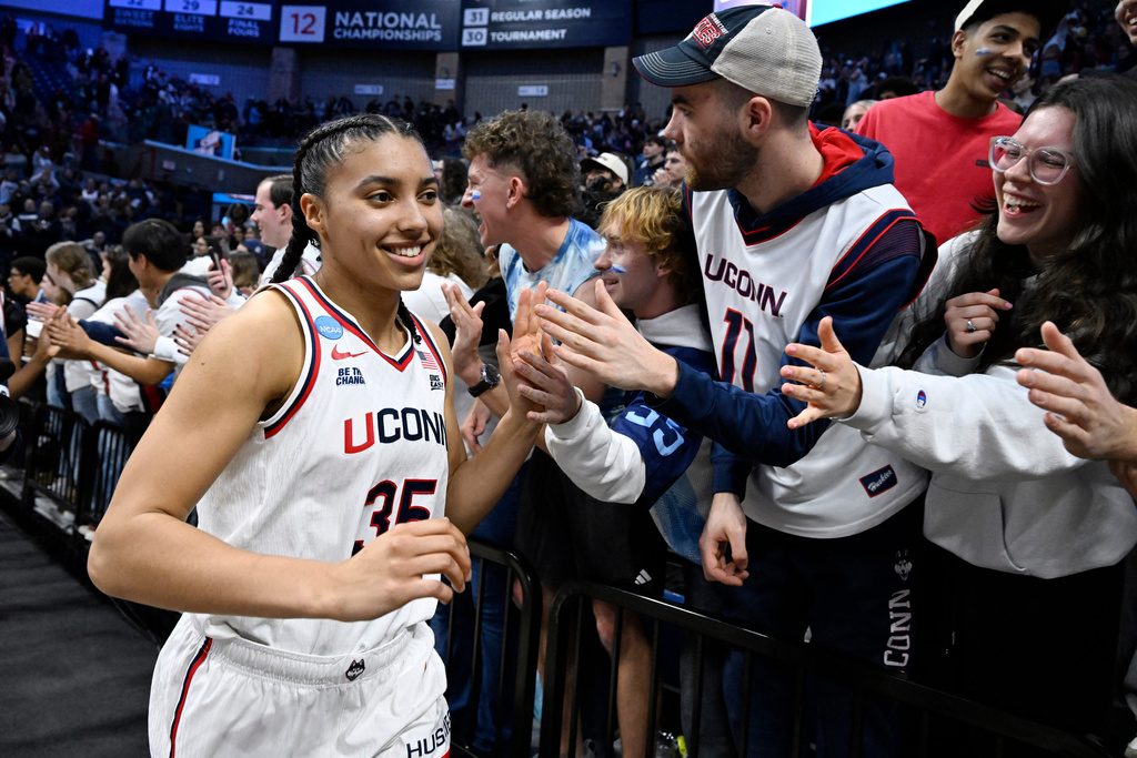 UConn guard Azzi Fudd (35) slaps hands with students at the end of a game against Syracuse in the second round of the NCAA college basketball tournament, Monday, March 23, 2026, in Storrs, Conn. (AP Photo/Jessica Hill)