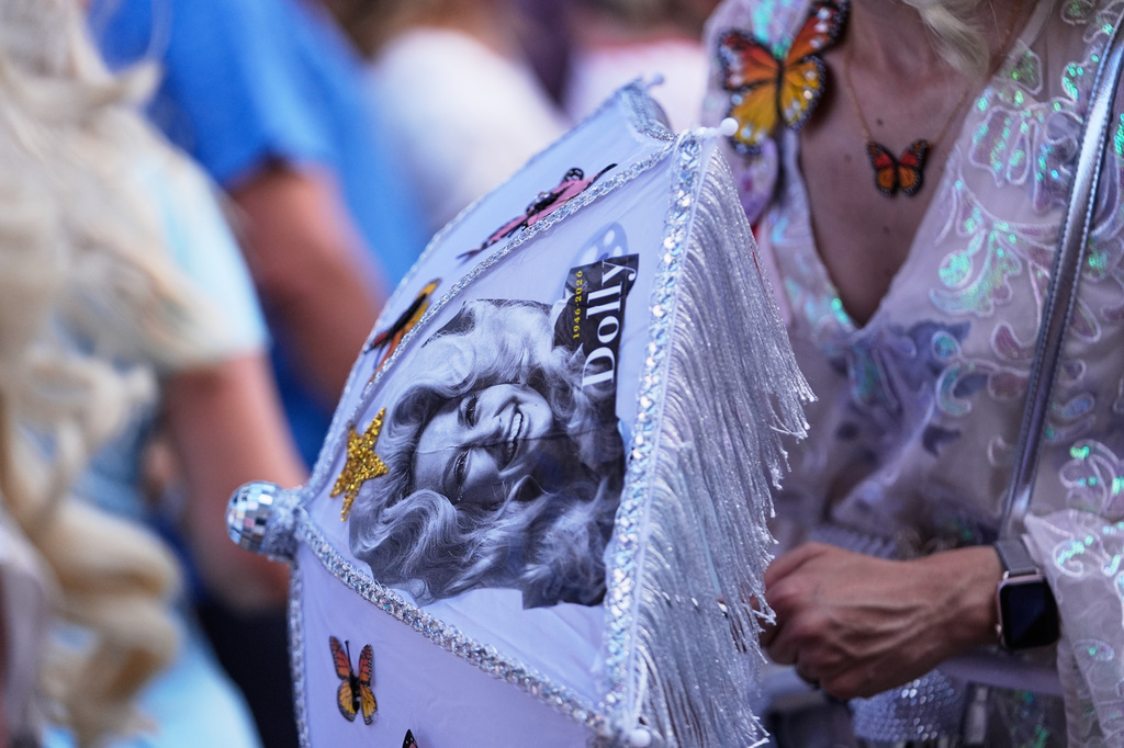 Members of the Krewe of Dolly lead a second line parade in commemoration of the life of Dolly Parton through the French Quarter Friday, Sept. 25, 2026, in New Orleans. (AP Photo/Gerald Herbert)