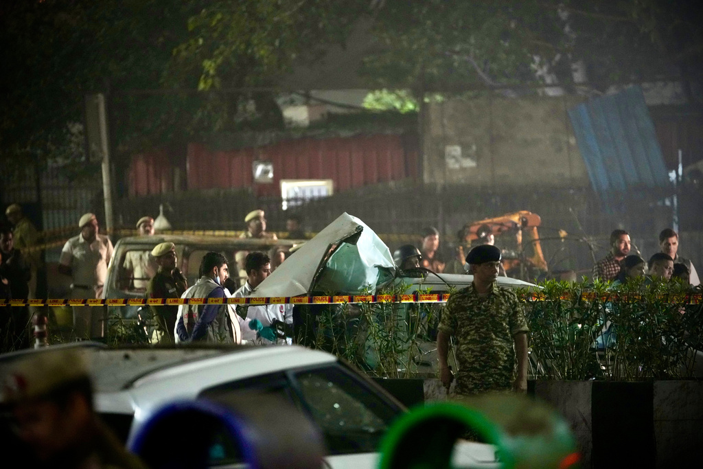 Security officials inspect damaged vehicles at the site after a car explosion near the historic Red Fort in New Delhi, India, Monday, Nov. 10, 2025. (AP Photo/Manish Swarup)
