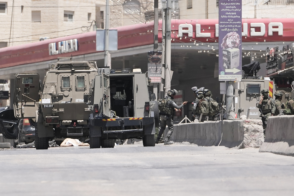 Israeli border police officers operate in the West Bank refugee camp of Qalandia, after Israeli forces shot and killed a suspected militant who opened fire on troops Monday, May 11, 2026. (AP Photo/Mahmoud Illean)