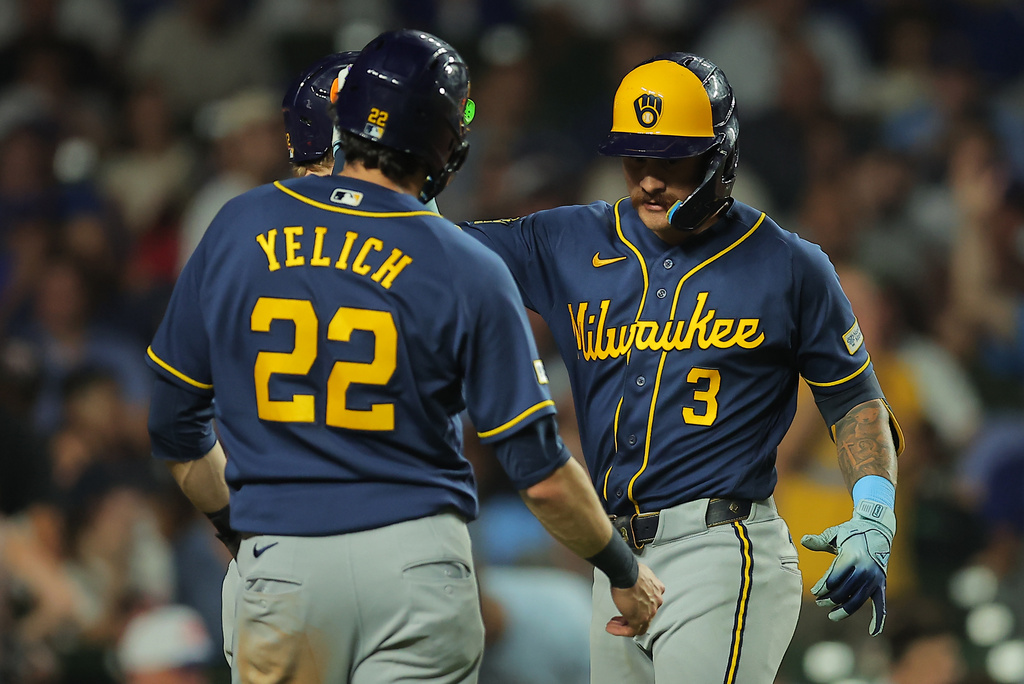 Milwaukee Brewers' Joey Ortiz, right, celebrates his two-run home run with teammate Christian Yelich, left, during the eighth inning of a baseball game against the Chicago Cubs, Tuesday, Sept. 1, 2026, in Chicago. (AP Photo/Melissa Tamez)