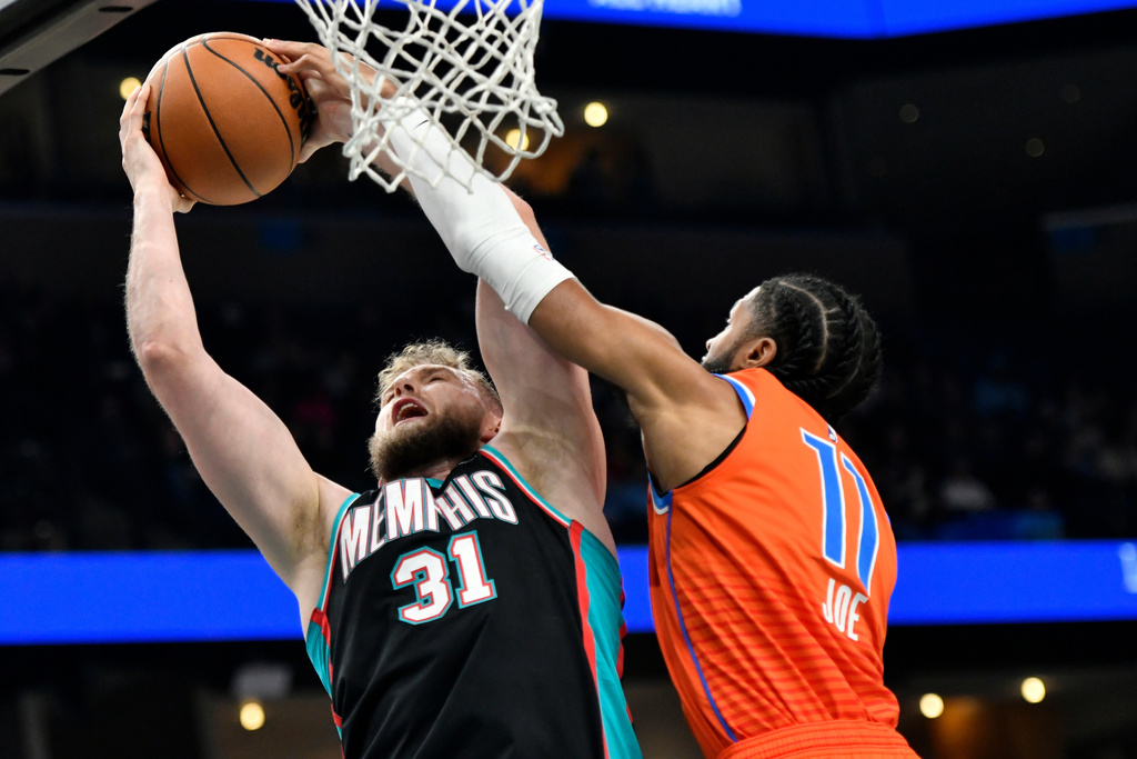 Memphis Grizzlies center Jock Landale (31) shoots against Oklahoma City Thunder guard Isaiah Joe (11) in the first half of an NBA basketball game Friday, Jan. 9, 2026, in Memphis, Tenn. (AP Photo/Brandon Dill)