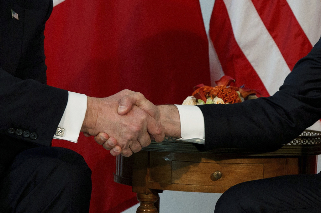 FILE - President Donald Trump shakes hands with French President Emmanuel Macron during a meeting at the U.S. Embassy, May 25, 2017, in Brussels. (AP Photo/Evan Vucci, file)