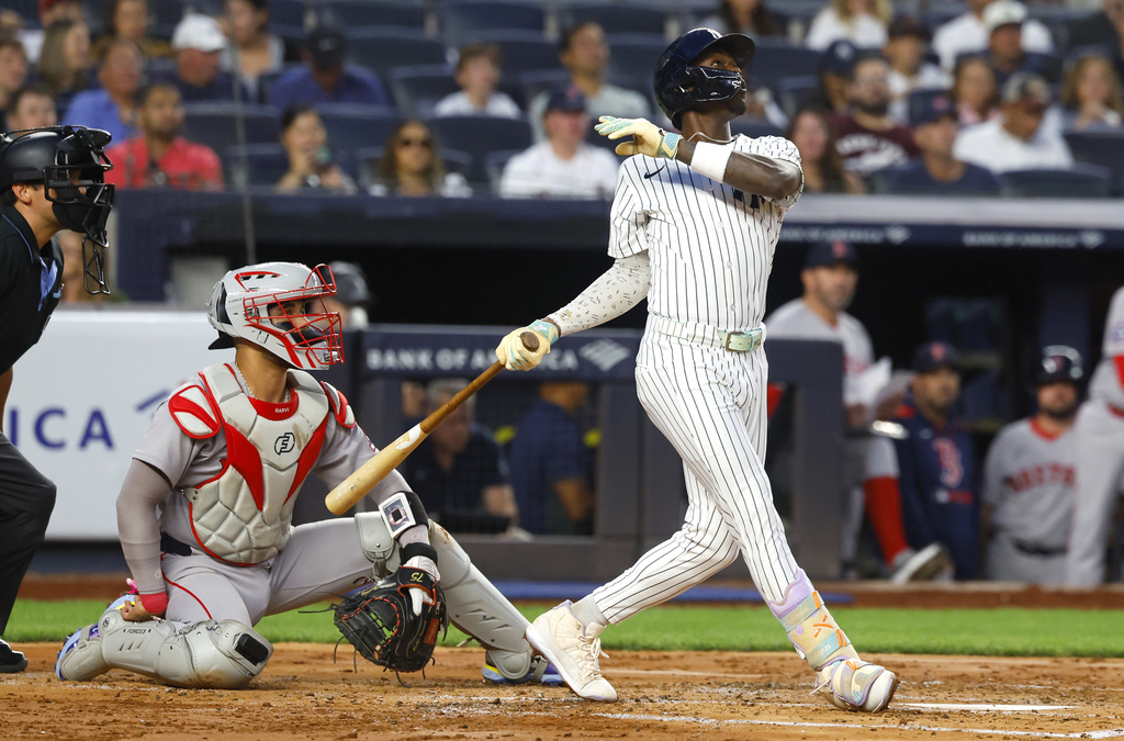 New York Yankees' Jazz Chisholm Jr. follows through on a two run home run during the second inning of a baseball game against the Boston Red Sox, Sunday, Aug. 24, 2025, in New York. (AP Photo/Noah K. Murray)