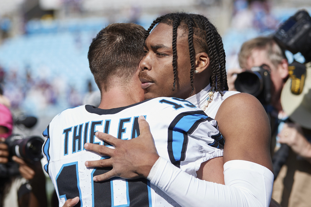 FILE - Minnesota Vikings wide receiver Justin Jefferson (18) hugs former teammate Carolina Panthers wide receiver Adam Thielen (19) following an NFL football game, Sunday, Oct. 1, 2023, in Charlotte, N.C. (AP Photo/Brian Westerholt, File)