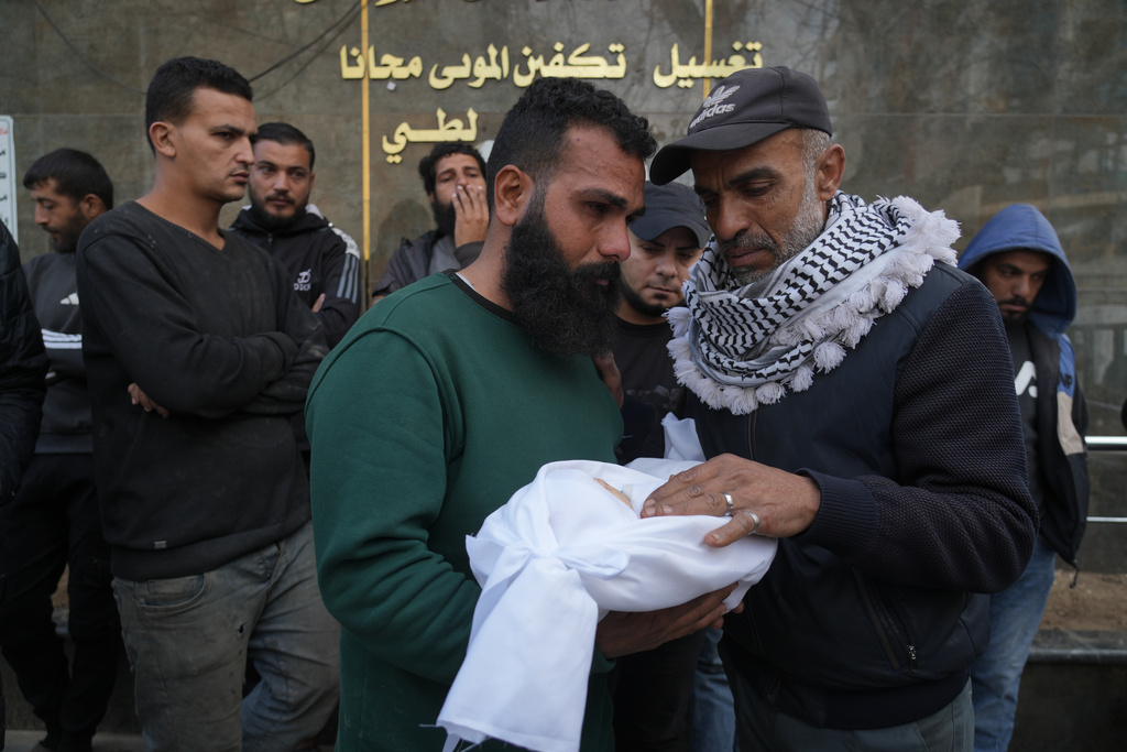 Palestinian Raed al-Khabba carries his 3-month-old daughter Mira al-Khabbaz, who was killed in an Israeli military strike, at Shifa Hospital in Gaza City, Wednesday, Feb. 4, 2026. (AP Photo/Jehad Alshrafi)