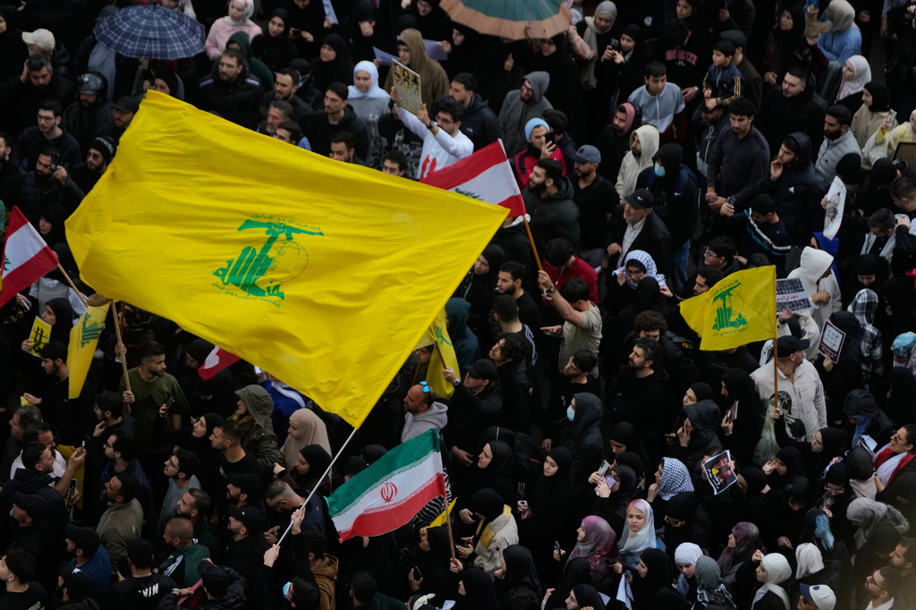 Protesters wave Hezbollah and Iran's flags during a protest against the Lebanese Prime Minister Nawaf Salam, in front the government palace in Beirut, Lebanon, Friday, April 10, 2026. (AP Photo/Hussein Malla)