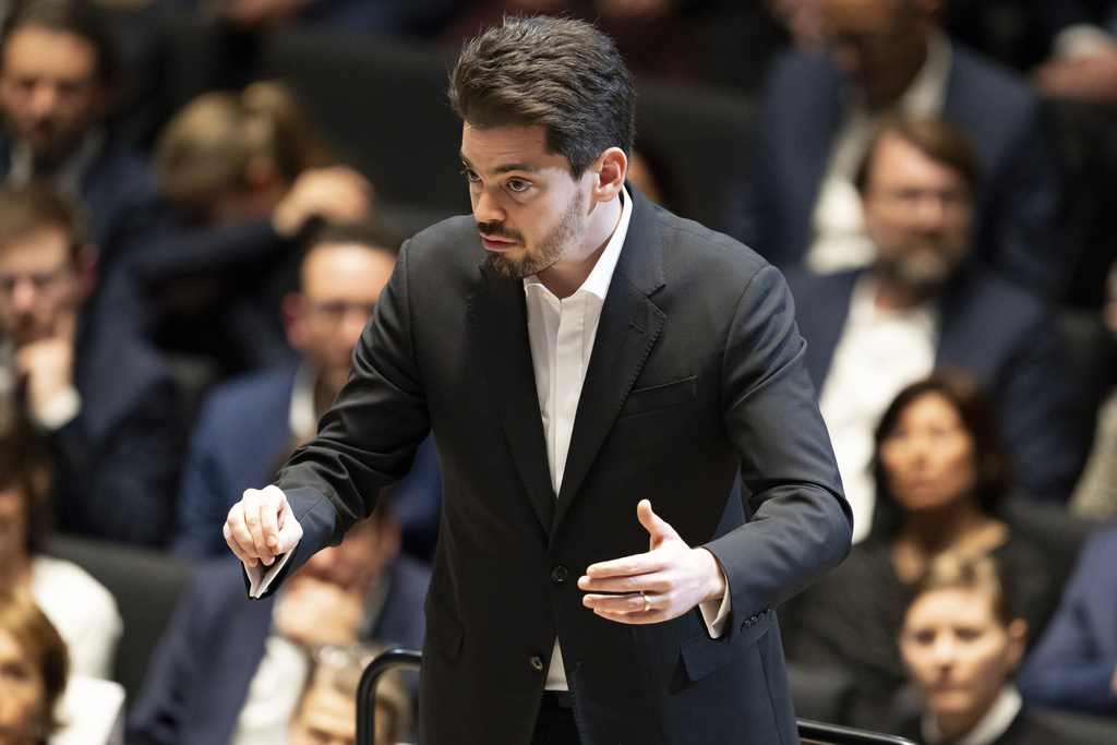 Israeli conductor Lahav Shani stands on stage after the awarding of the City of Munich's Golden Medal of Honor to conductor Zubin Mehta, in Munich, Germany, Jan. 26, 2024. (Sven Hoppe/dpa via AP)