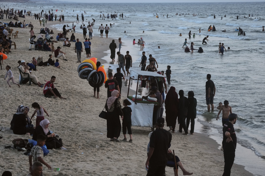 Palestinians cool off in the Mediterranean Sea during a heat wave in Gaza City, Monday, Aug. 3, 2026. (AP Photo/Jehad Alshrafi)