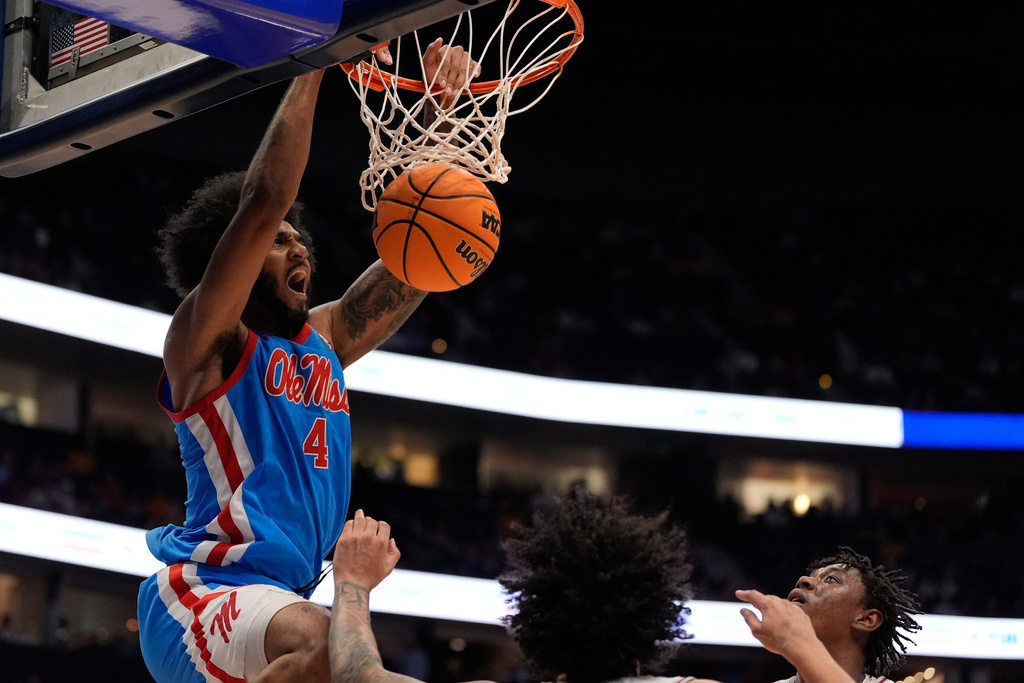 Mississippi forward Malik Dia (0) dunks against Alabama guard Houston Mallette (95) during the first half of an NCAA college basketball game in the quarterfinal round of the Southeastern Conference tournament, Friday, March 13, 2026, in Nashville, Tenn. (AP Photo/George Walker IV)