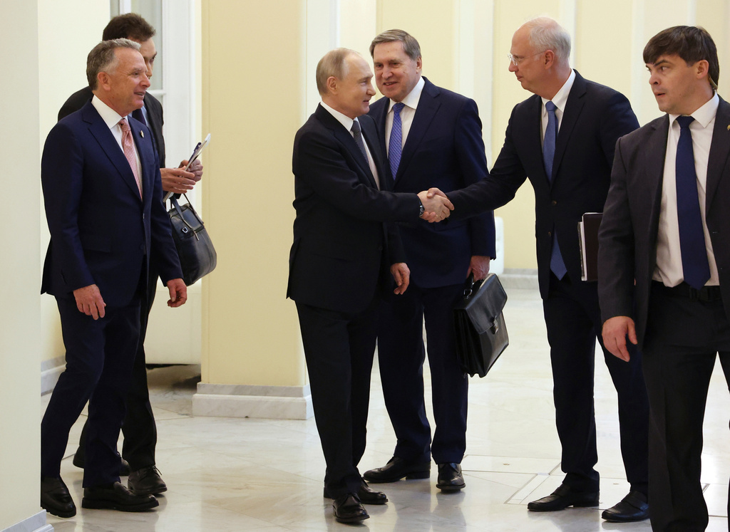 FILE - Russian President Vladimir Putin, center, shakes hands with his envoy Kirill Dmitriev as U.S. President Donald Trump's special envoy Steve Witkoff, left, looks on, before talks in St. Petersburg, Russia, on April 11, 2025. (Vyacheslav Prokofyev, Sputnik, Kremlin Pool Photo via AP, File)