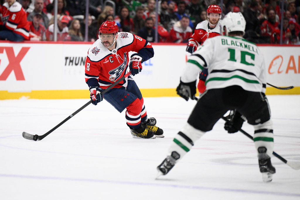 Washington Capitals left wing Alex Ovechkin (8) skates with the puck against Dallas Stars center Colin Blackwell (15) during the first period of an NHL hockey game, Wednesday, Jan. 7, 2026, in Washington. (AP Photo/Nick Wass)