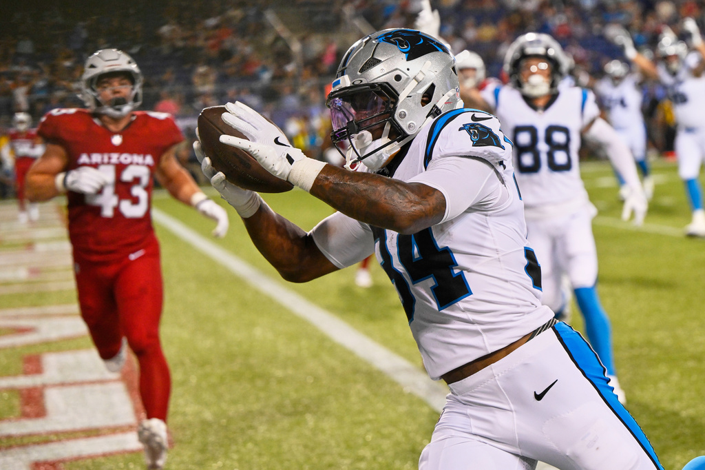 Carolina Panthers running back Anthony Tyus III runs to the end zone in front of Arizona Cardinals linebacker Karson Sharar (43) after a catch in the second half of the Pro Football Hall of Fame NFL preseason game in Canton, Ohio, Thursday, Aug. 6, 2026. (AP Photo/David Richard)