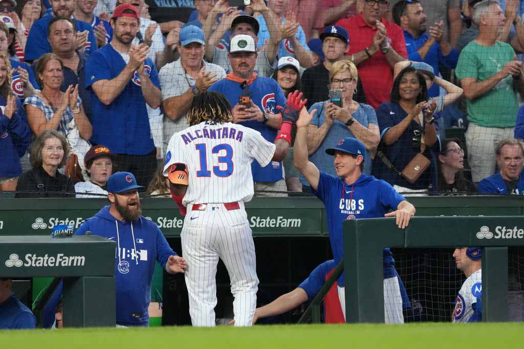 Chicago Cubs' Kevin Alcantara (13) is greeted at the dugout after hitting a two-run home run against the Los Angeles Dodgers during the second inning of a baseball game Monday, Aug. 3, 2026, in Chicago. (AP Photo/David Banks)