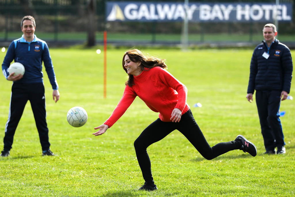 FILE - Kate the Duchess of Cambridge, centre, plays Gaelic football at Salthill Knocknacarra GAA Club in Galway, Ireland, Thursday, March 5, 2020. (AP Photo/Peter Morrison, File)