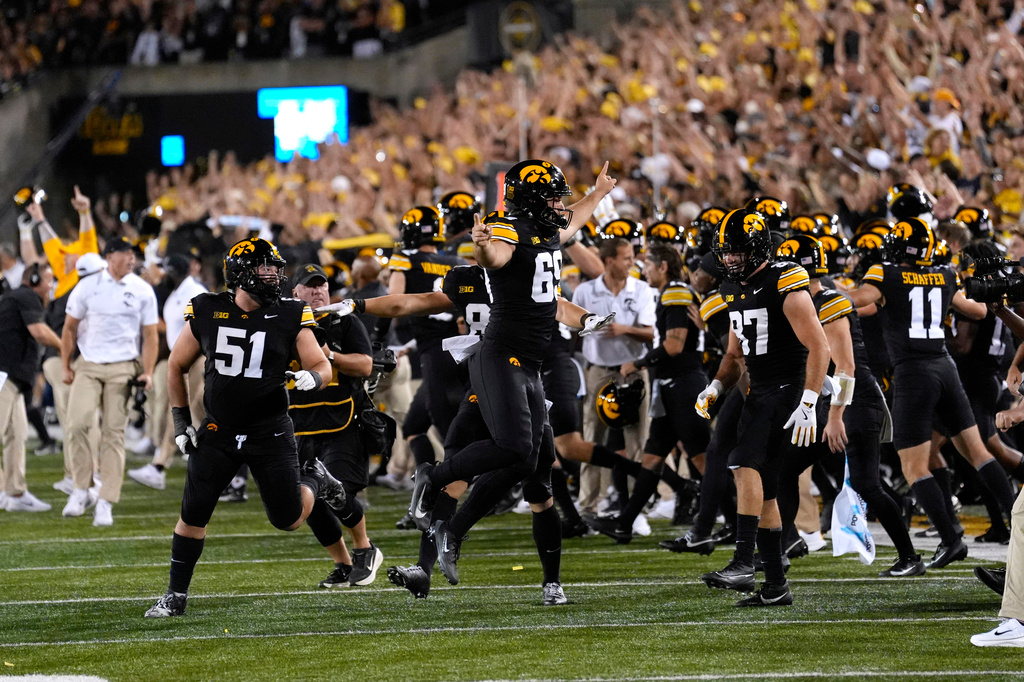 Iowa players celebrate at the end of an NCAA college football game against Iowa State, Saturday, Sept. 12, 2026, in Iowa City, Iowa. (AP Photo/Charlie Neibergall)