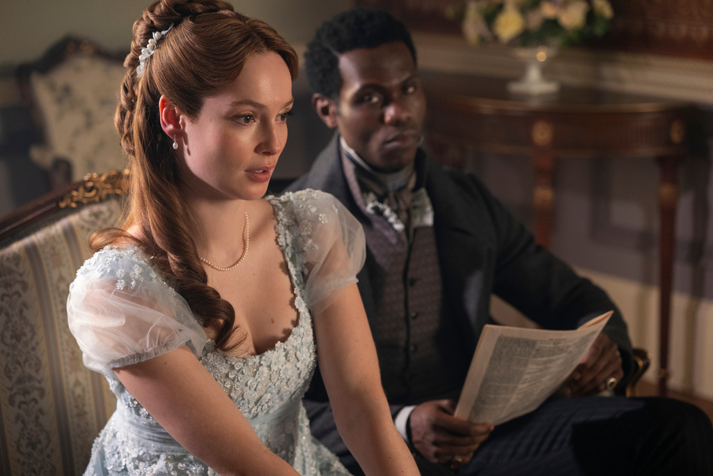 This image released by Netflix shows Hannah Dodd as Francesca Bridgerton, left, and Victor Alli as John Stirling, in a scene from "Bridgerton." (Liam Daniel/Netflix via AP)