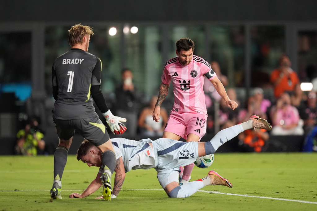 Inter Miami forward Lionel Messi (10) attempts to score past Chicago Fire goalkeeper Chris Brady (1) and defender Joel Waterman (16) during the first half of an MLS soccer match, Tuesday, Sept. 30, 2025, in Fort Lauderdale, Fla. (AP Photo/Rebecca Blackwell)