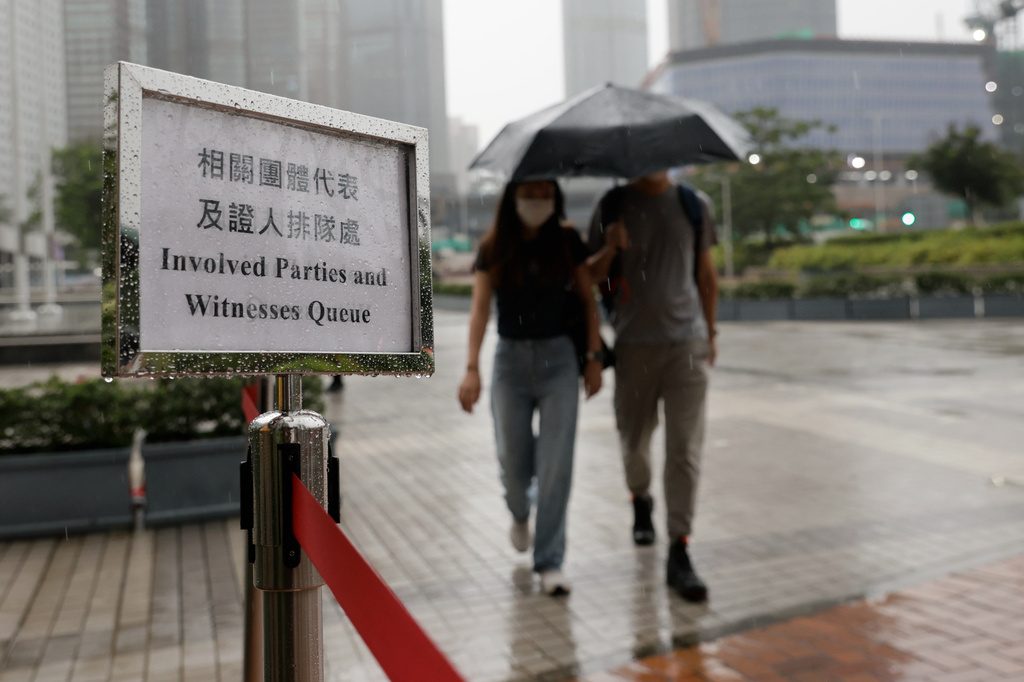 Member of the public arrives for the closing submissions at the Independent Commission investigation hearing into last year's Tai Po deadly fire, in Hong Kong, Friday, July 17, 2026. (AP Photo/May James)