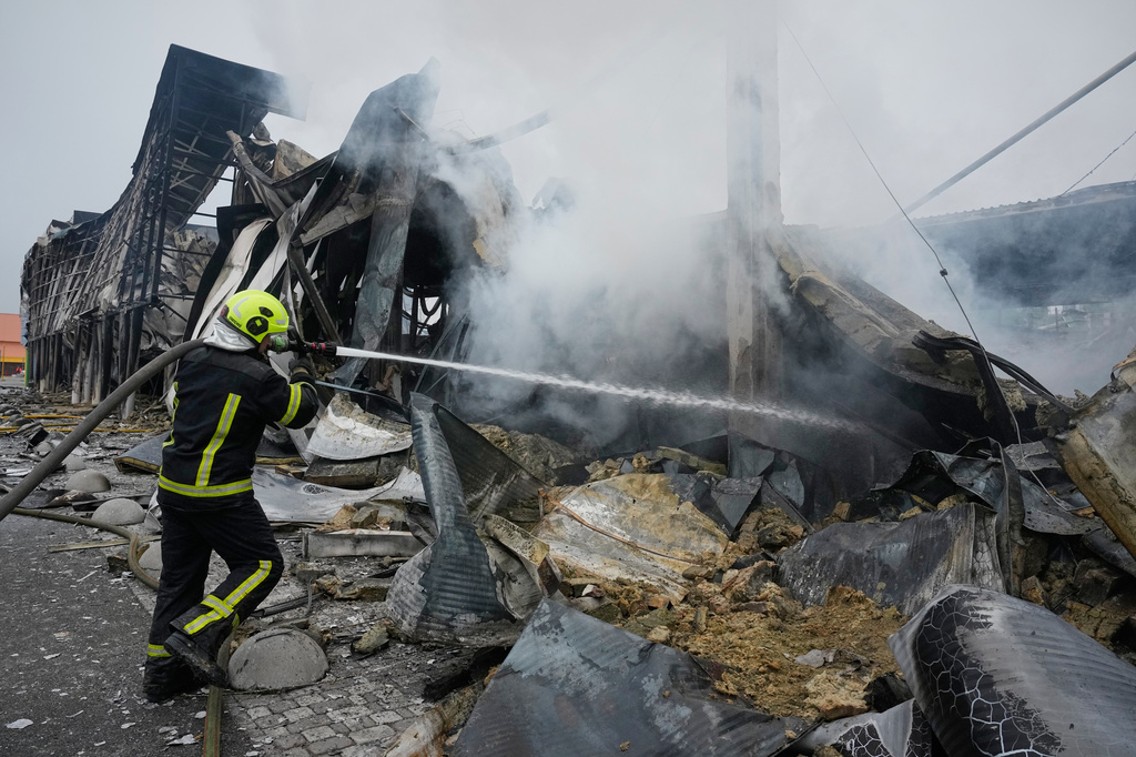 Firefighters try to extinguish a fire after a Russian missile attack in central Kyiv, Ukraine, Thursday, Oct. 22, 2026. (AP Photo/Efrem Lukatsky)