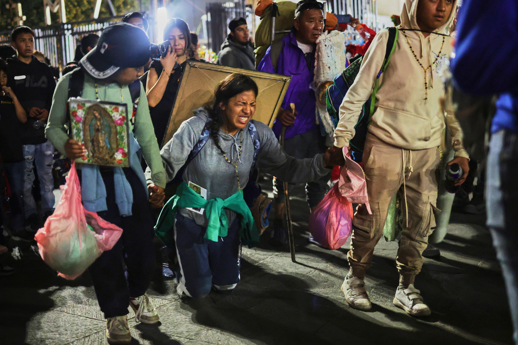 Pilgrims arrive at Our Lady of Guadalupe Basilica in Mexico City, Thursday, Dec. 11, 2025, the night before her feast day. (AP Photo/Claudia Rosel)