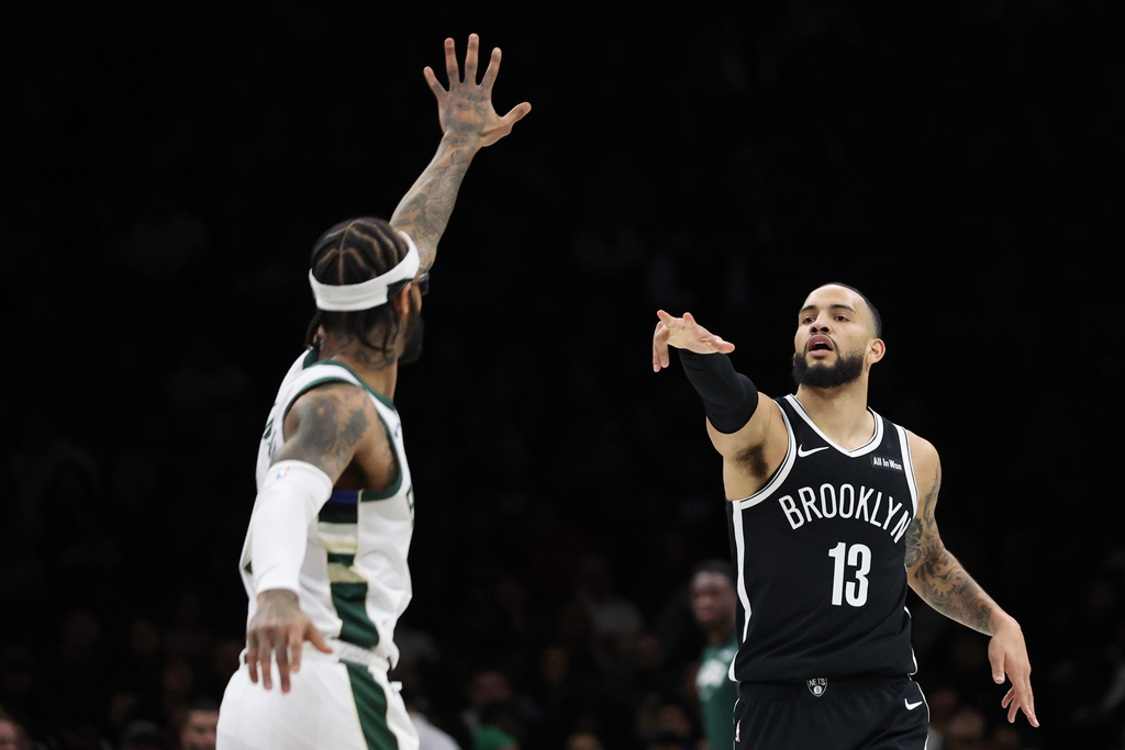 Brooklyn Nets guard Tyrese Martin (13) celebrates a three-point basket during the first half of an NBA basketball game against the Milwaukee Bucks, Sunday, Dec. 14, 2025, in New York. (AP Photo/Heather Khalifa)