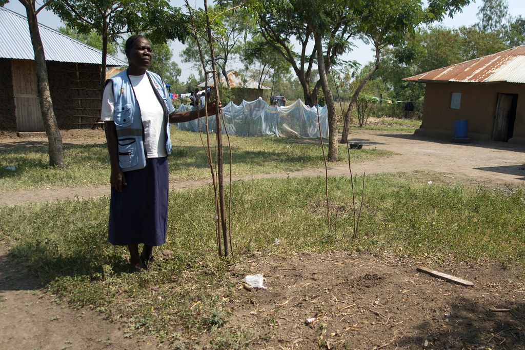 Community health worker Loice Ochieng stands over the grave of Mary Olouch, who died at 25 after a botched abortion procedure done without the help of healthcare professionals, in Karabok, Kenya, July 20, 2025. (AP Photo/Annie Risemberg)