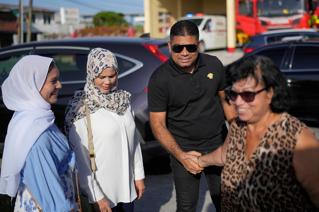 FILE - Presidential candidate Azruddin Mohamed of the We Invest in Nationhood party greets supporters after voting in general elections in Georgetown, Guyana, Sept. 1, 2025. (AP Photo/Matias Delacroix, File)