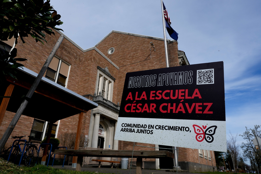 A sign is seen outside Cesar Chavez School on Wednesday, March 18, 2026, in Portland, Ore. (AP Photo/Jenny Kane)