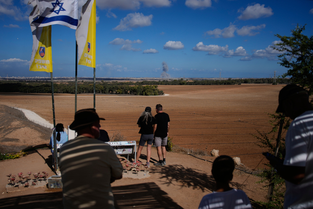 Smoke rises from an Israeli army bombardment in the Gaza Strip, seen from a memorial site for Israelis killed in the Oct. 7, 2023, Hamas attack, as Israel marks the second anniversary since the attack, Tuesday, Oct. 7, 2025. (AP Photo/Ohad Zwigenberg)