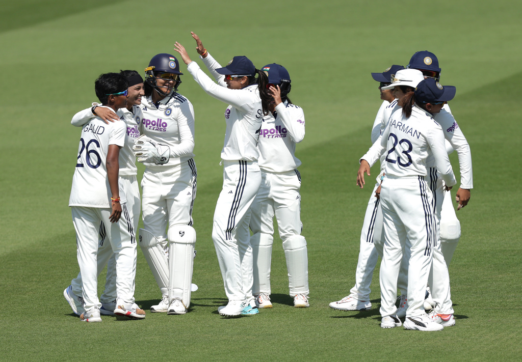 India's players celebrate the wicket of England's Amy Jones, who was caught out by Shafali Verma during day four of the first Women's Rothesay Test between England and India in London, England, Monday, July 13, 2026. (Steven Paston/PA via AP)