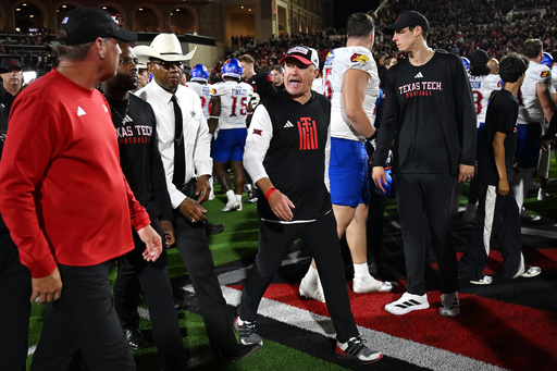 Texas Tech head coach Joey McGuire, center, speaks to Kansas head coach Lance Leipold, left, after the end of the NCAA college football game, Saturday, Oct. 11, 2025, in Lubbock, Texas. (AP Photo/Annie Rice) Texas Tech head coach Joey McGuire, center, speaks to Kansas head coach Lance Leipold, left, after the end of the NCAA college football game, Saturday, Oct. 11, 2025, in Lubbock, Texas. (AP Photo/Annie Rice)