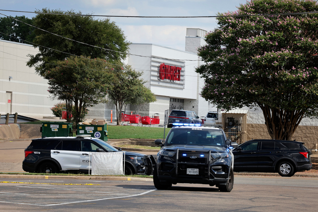 Police monitor the scene near a Target after a shooting in Austin, Texas, Monday, Aug. 11, 2025. (AP Photo/Stephen Spillman)