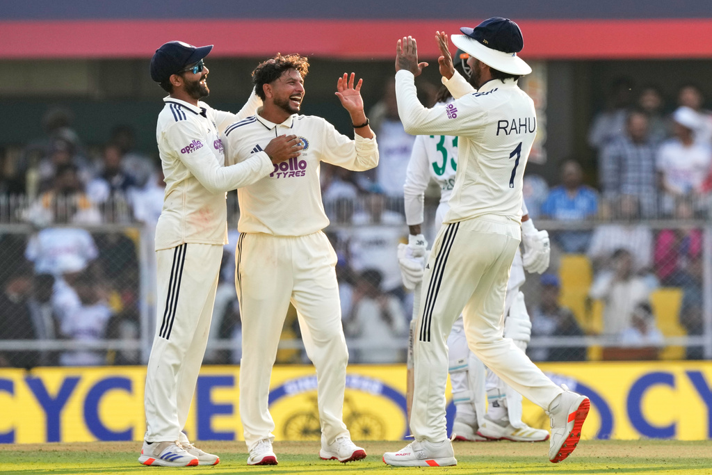 India's Kuldeep Yadav, centre, celebrates with teammates after the dismissal of South Africa's Wiaan Mulder on the first day of the second cricket test match between India and South Africa in Guwahati, India, Saturday, Nov. 22, 2025. (AP Photo/Anupam Nath)