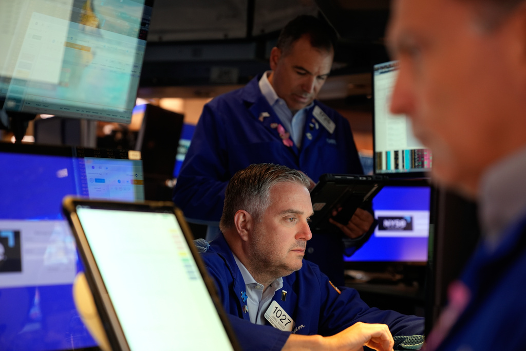 James Bodner, center, and others work on the floor at the New York Stock Exchange in New York, Wednesday, Oct. 1, 2025. (AP Photo/Seth Wenig)