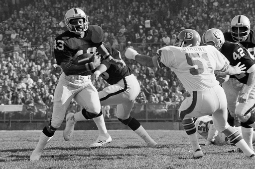 FILE - George Atkinson (43), of the Oakland Raiders, breaks inside Mike Simone (51) of the Denver Broncos as he returned a Broncos punt 32 yards, in Oakland, Calif., Dec. 16, 1973. (AP Photo, file) FILE - George Atkinson (43), of the Oakland Raiders, breaks inside Mike Simone (51) of the Denver Broncos as he returned a Broncos punt 32 yards, in Oakland, Calif., Dec. 16, 1973. (AP Photo, file)