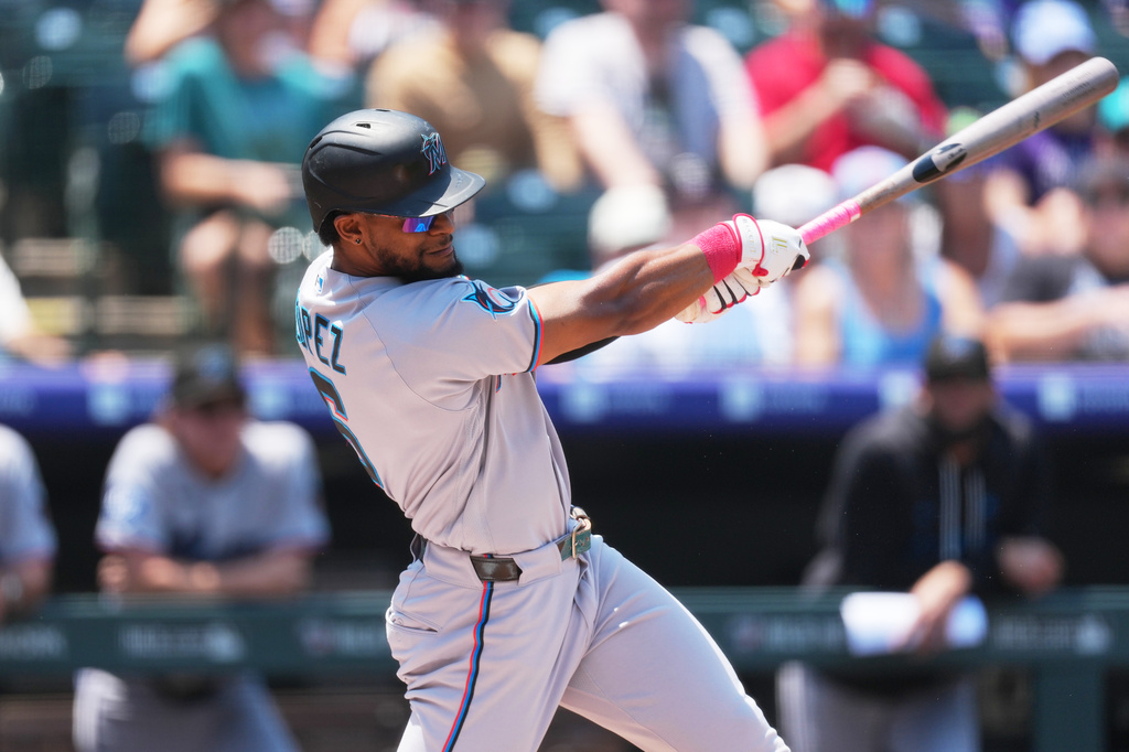 Miami Marlins' Otto Lopez doubles off Colorado Rockies starting pitcher Michael Lorenzen in the first inning of a baseball game Thursday, July 2, 2026, in Denver. (AP Photo/David Zalubowski)