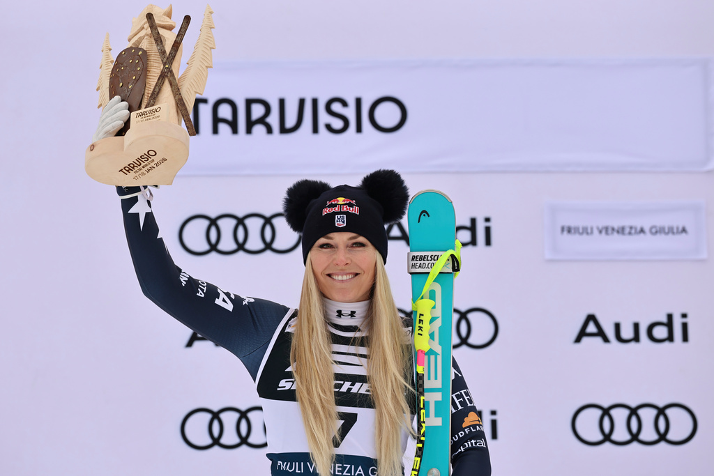 United States' Lindsey Vonn celebrates on the podium after taking second place in an alpine ski, women's World Cup Super G, in Tarvisio, Italy, Sunday, Jan. 18, 2026. (AP Photo/Marco Trovati)