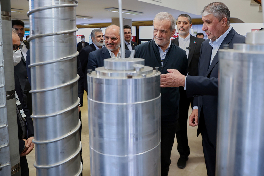 FILE - In this photo released by the Iranian Presidency Office, President Masoud Pezeshkian, second right, listens to head of Atomic Energy Organization of Iran Mohammad Eslami as he visits an exhibition of Iran's nuclear achievements, in Tehran, Iran, April 9, 2025. (Iranian Presidency Office via AP, File)
