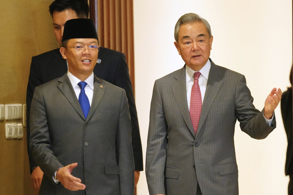 China's Foreign Minister Wang Yi, right, walks with his Indonesian counterpart Sugiono for the Comprehensive Strategic Dialogue between Indonesia and China in Jakarta, Indonesia, Friday, Aug. 21, 2026. (AP Photo/Tatan Syuflana)