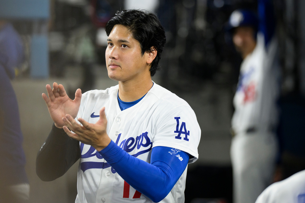 Los Angeles Dodgers' Shohei Ohtani applauds during the fourth inning of a baseball game against the San Diego Padres in Los Angeles, Thursday, July 2, 2026. (AP Photo/Kyusung Gong)